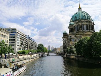 View of buildings against cloudy sky