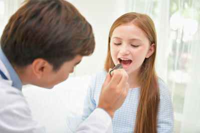 Doctor examining girl in hospital