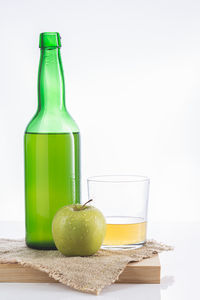 Close-up of apples in glass against white background