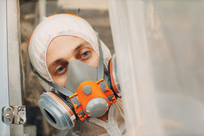 Portrait of man wearing mask against wall