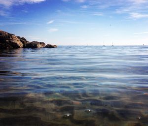 Surface level of calm blue sea against sky