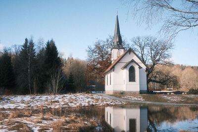 Built structure in lake. wood church in harz mountains. elend, germany