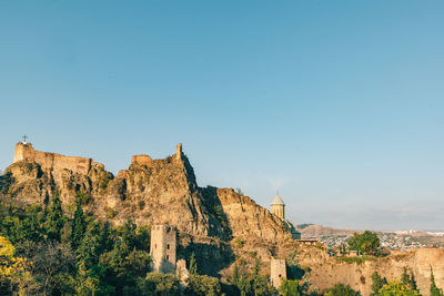 Low angle view of fort against clear blue sky