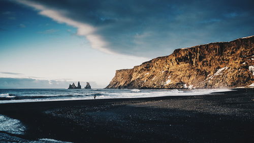 Scenic view of sea against cloudy sky