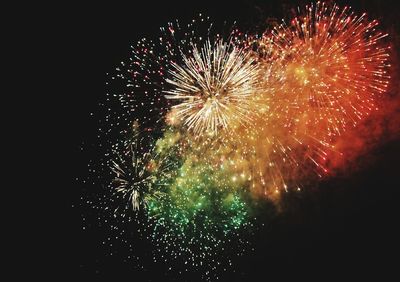 Low angle view of firework display at night