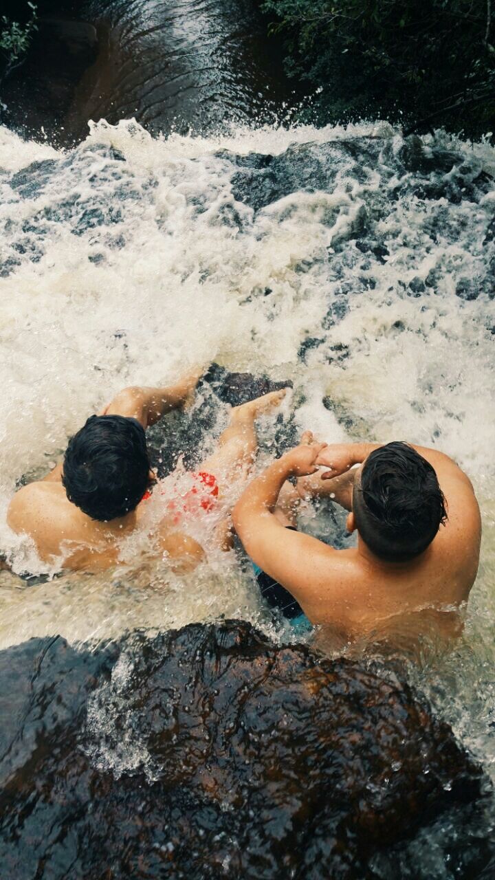 water, leisure activity, lifestyles, beach, high angle view, rock - object, sea, shore, barefoot, low section, sand, outdoors, person, childhood, surf, vacations, day