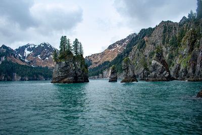 Scenic view of sea and mountains against sky