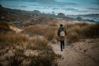 Rear view of man standing on land