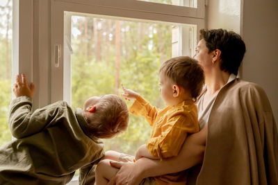 Happy grandmother and her grandsons enjoy time together. positive middle age woman