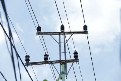 Low angle view of electricity pylon against sky