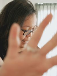 Close-up of woman showing stop gesture