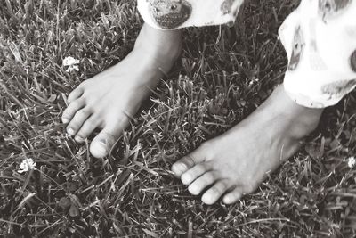 Cropped image of woman standing on grassy field