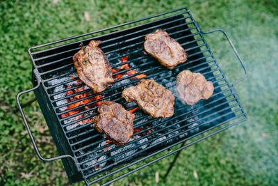 High angle view of meat on barbecue grill