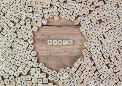 Directly above shot of coach text amidst wooden cubes