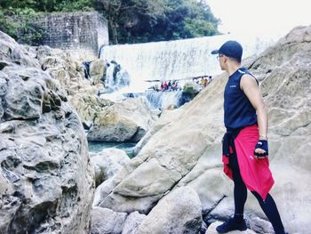 Full length side view of man standing on rock