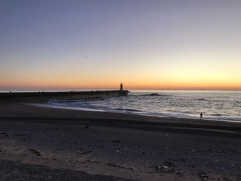 Scenic view of sea against clear sky during sunset