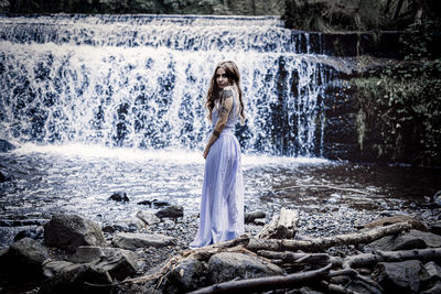 Woman looking at waterfall