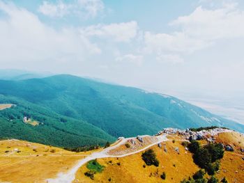 Scenic view of landscape and sea against sky