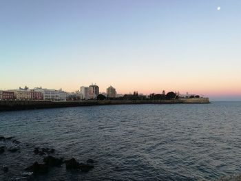 Scenic view of sea against clear sky during sunset