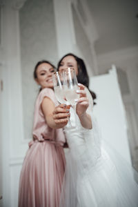 Midsection of woman drinking glass