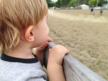 Close-up of cute girl looking at park