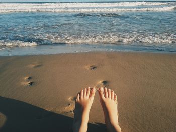 Low section of person on shore at beach