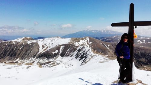 Woman on snow covered mountain