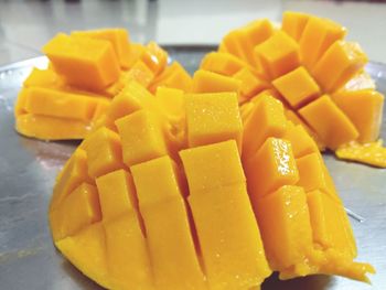 Close-up of yellow slices in plate on table