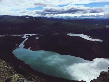 Scenic view of lake and mountains against sky