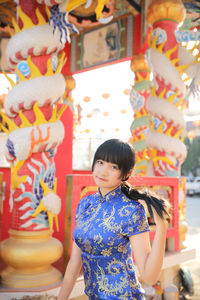 Portrait of young woman standing outdoors