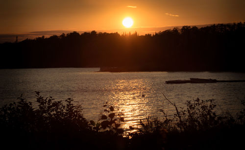 Scenic view of calm lake at sunset