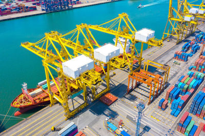 Container ship in export and import business and logistics. shipping cargo to harbor by crane.