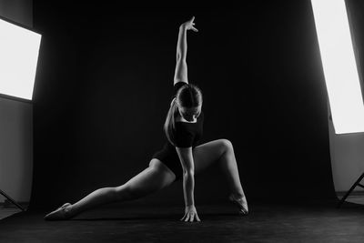 Side view of woman exercising in gym