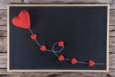 Directly above shot of red heart shape on table