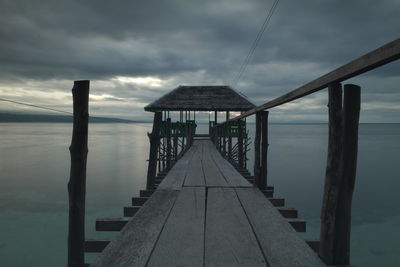 Pier over sea against sky at dusk