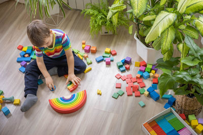 High angle view of boy playing with toys on table