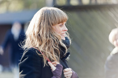 Mid-adult woman looking away in city