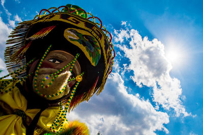 Low angle view of man wearing costume against sky during sunny day