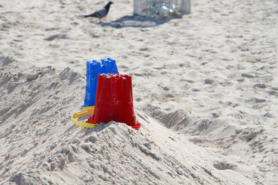 High angle view of upside down buckets on sand at beach