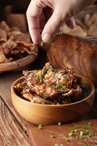 Close-up of hand holding food on table