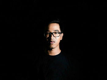 Portrait of man in black background