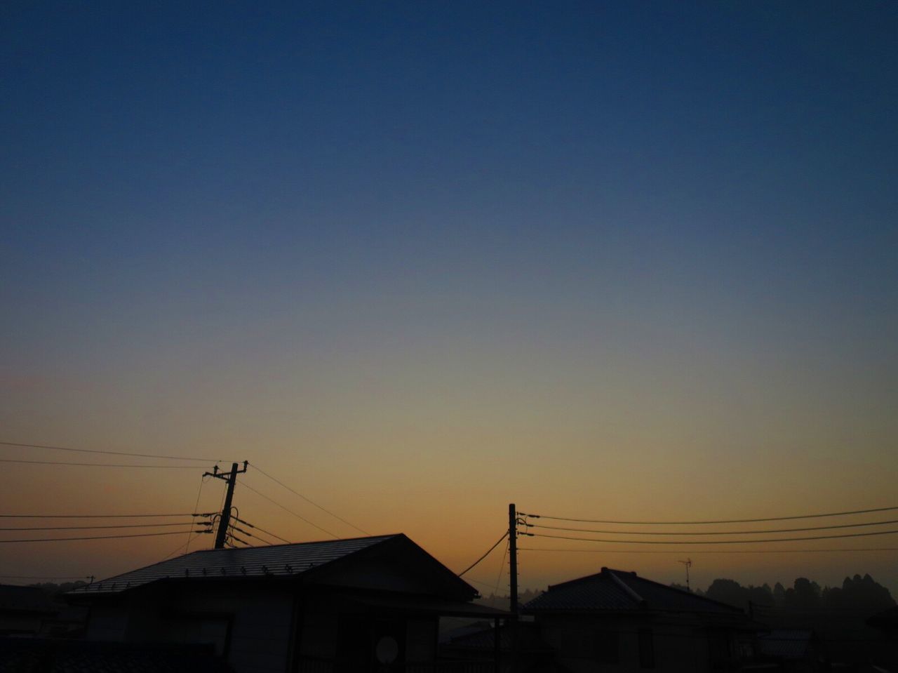 LOW ANGLE VIEW OF SILHOUETTE BUILDINGS AGAINST CLEAR SKY