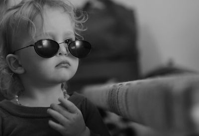 Close-up portrait of cute boy wearing sunglasses