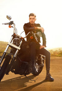 Portrait of man riding bicycle on field