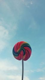 Low angle view of red flower against blue sky