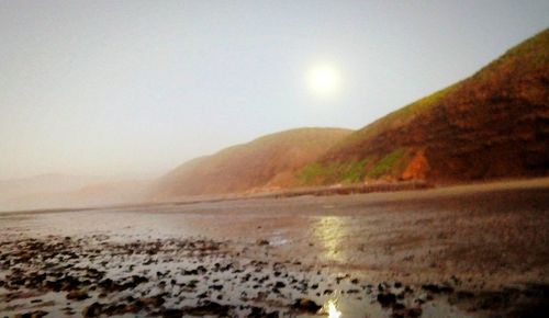 Scenic view of sea against clear sky during sunset