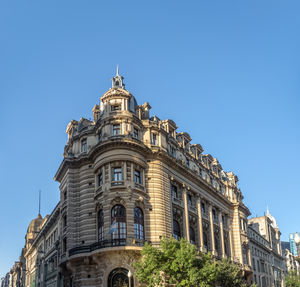 Low angle view of building against clear blue sky