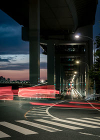 Light trails on bridge in city at night