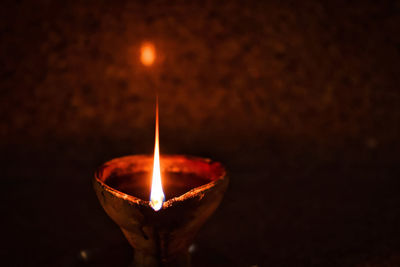 Close-up of illuminated lamp against black background