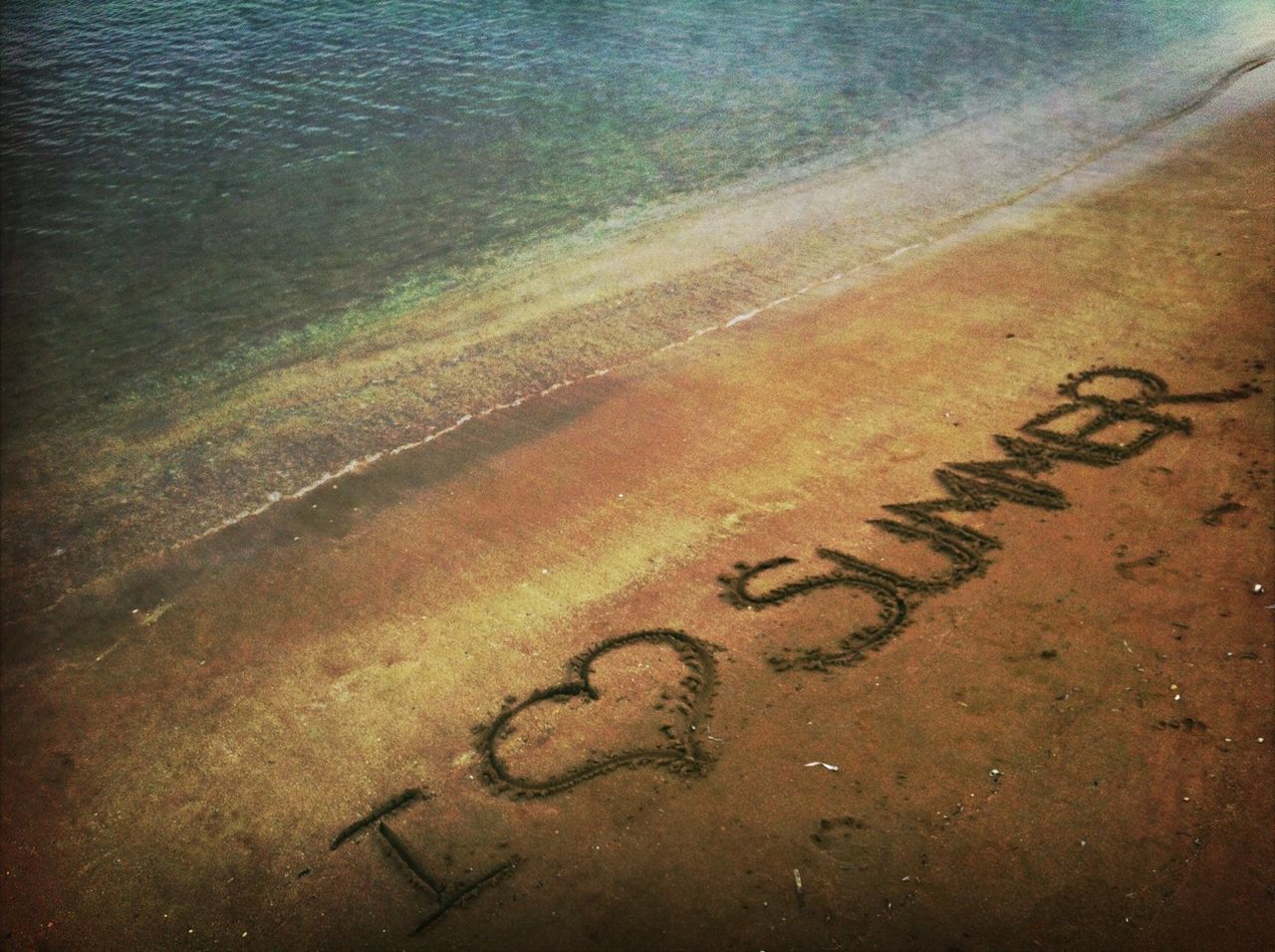 beach, sand, water, sea, text, shore, western script, high angle view, communication, footprint, tranquility, nature, outdoors, wave, surf, no people, tranquil scene, day, coastline, capital letter